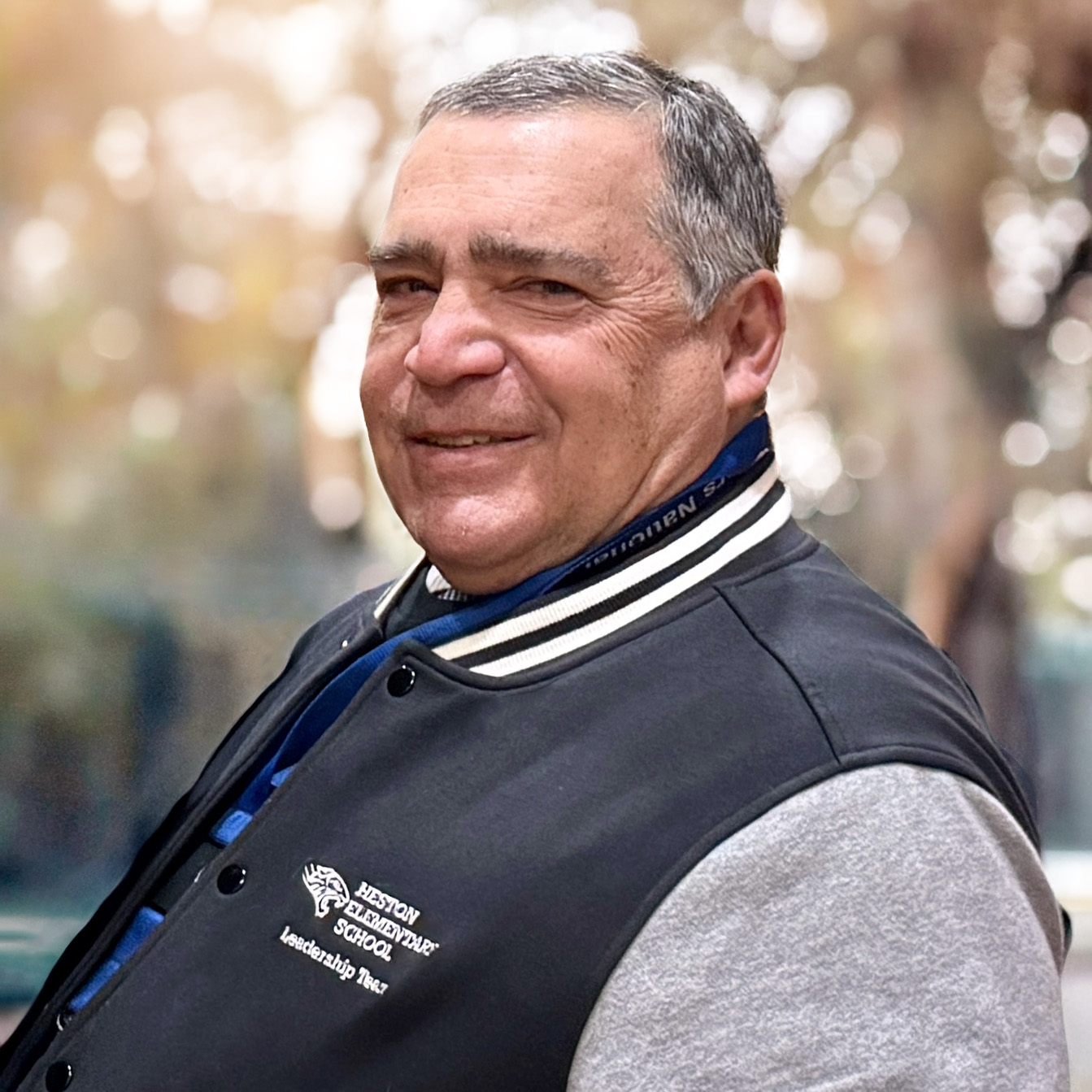 Portrait of Donald J. Anticoli, Principal of Edward Heston School in Philadelphia, smiling while wearing a school leadership jacket.